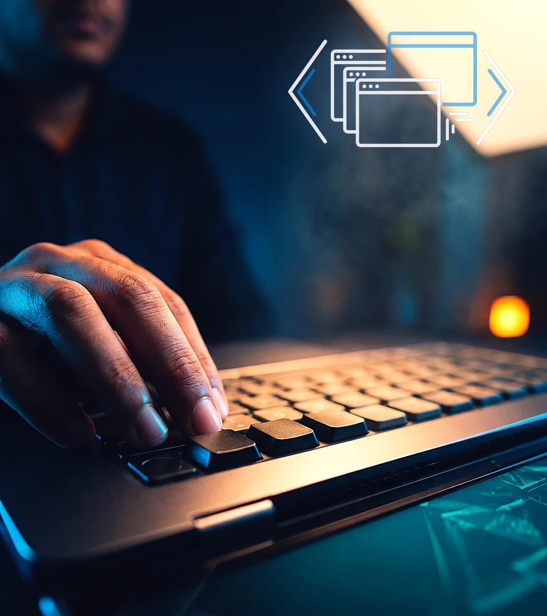 A hand caught mid-keystroke on a backlit keyboard in a darkened studio